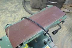 General International Model 15-015M1 Belt/Disc Sander.  12" Disc, 6" Wide Belt, 7"x16" Slotted Tilting Table, Cabinet Base, 120V Single Phase