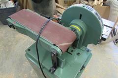 General International Model 15-015M1 Belt/Disc Sander.  12" Disc, 6" Wide Belt, 7"x16" Slotted Tilting Table, Cabinet Base, 120V Single Phase