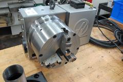 Haas HRT-A6 Brushless Drive Rotary Table with Cables and Interface, 8.25" 3-Jaw Chuck, Sigma-1 Servo Motor, A1-6 Spindle Nose Mount, 16C Air Collet Closer.