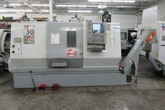 Haas SL-30 2-Axis CNC Turning Center with Programmable Tailstock, Tool Presetter, Chip Conveyor, and more.