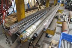 Raw Material Contents of Bar Stock Area Including (4) Racks, Material On Floor up to 17" x 98" Round Steel Bar, Aluminum, and More.  THOUSANDS OF POUNDS OF STEEL!!