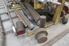 Raw Material Contents of Bar Stock Area Including (4) Racks, Material On Floor up to 17" x 98" Round Steel Bar, Aluminum, and More.  THOUSANDS OF POUNDS OF STEEL!!