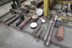 Raw Material Contents of Bar Stock Area Including (4) Racks, Material On Floor up to 17" x 98" Round Steel Bar, Aluminum, and More.  THOUSANDS OF POUNDS OF STEEL!!