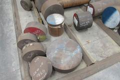 Raw Material Contents of Bar Stock Area Including (4) Racks, Material On Floor up to 17" x 98" Round Steel Bar, Aluminum, and More.  THOUSANDS OF POUNDS OF STEEL!!