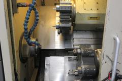 Hardinge Conquest T-42 CNC 3-Axis 2-Turret Turning Center with Har-Matic Bar Feeder Fanuc Series 18-T Control, Chip Conveyor and More