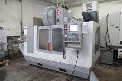 Haas VF-3 CNC Vertical Machining Center with 15,000 RPM CT-40 Spindle, 4th Axis Ready, 40 Station Side Mount Tool Changer,  Probing, Macros, Thru-Spindle Coolant, Mist Collector, and Chip Auger.
