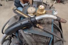 Miller XMT 304 with Wire Feeder, MIG Gun, Ground Clamps, Regulator and Cart