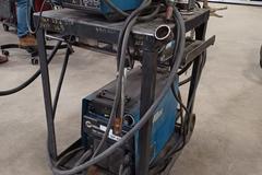Miller XMT 304 with Wire Feeder, MIG Gun, Ground Clamps, Regulator and Cart