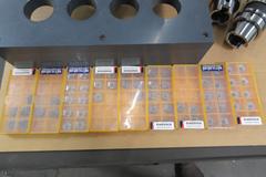 HSK63 Face Mill Holders and Face Mills (4) 2" Face Mills, (2) 2-1/2" Face Mills, with Tool Rack and Assorted Carbide Inserts