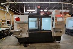 2022 Haas VF-5 CNC Vertical Machining Center with 30,000 RPM Spindle, Side Mount Tool Changer, Programmable Coolant Nozzle, High Speed Machining and More