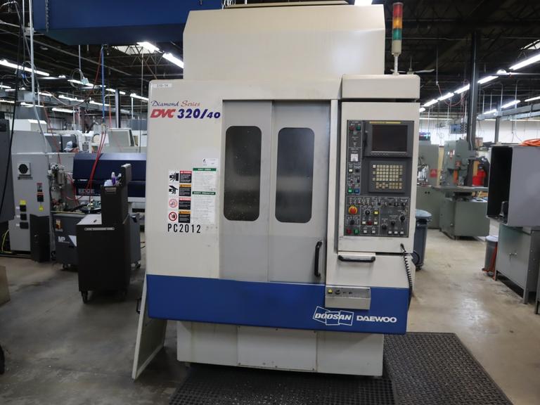 Daewoo Doosan 320/40 CNC Vertical Machining Center with 2 Station Pallet Changer, 12,000 RPM Spindle, 14 Station Rotary Turret, Chip Conveyor