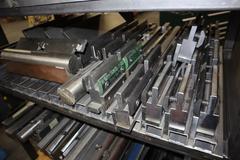 Amada Press Brake Dies, Ram Clamps and Lower Die Holders on Steel Rack