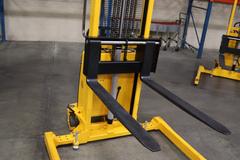 Uline H-5439 Electric Straddle Stacker Lift, 2,200# Cap, 63" Max Height, 50" Between Outriggers, 12 Volt Battery with Charger, 42" Forks