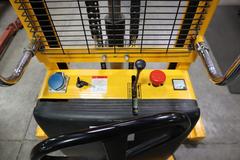 Uline H-2651 Electric Straddle Stacker Lift, 2,200# Cap, 63" Max Height, 50" Between Outriggers, 12 Volt Battery with Charger, 42" Forks