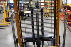 Uline H-5439 Electric Straddle Stacker Lift, 2,200# Cap, 63" Max Height, 50" Between Outriggers, 12 Volt Battery with Charger, 42" Forks