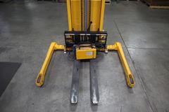 Uline H-2651 Electric Straddle Stacker Lift, 2,200# Cap, 63" Max Height, 50" Between Outriggers, 12 Volt Battery with Charger, 42" Forks