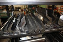 Amada Press Brake Dies, Ram Clamps and Lower Die Holders on Steel Rack
