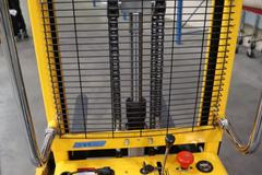 Uline H-5439 Electric Straddle Stacker Lift, 2,200# Cap, 63" Max Height, 50" Between Outriggers, 12 Volt Battery with Charger, 42" Forks