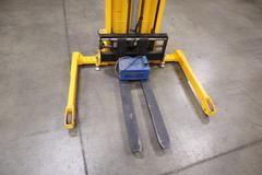 Uline H-2651 Electric Straddle Stacker Lift, 2,200# Cap, 63" Max Height, 50" Between Outriggers, 12 Volt Battery with Charger, 42" Forks