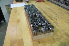CAT 40 TSD Collet Tool Holders with assorted TSD Flex Collets in Wooden Rack