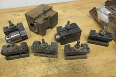 Aloris, Dorian, and Other CXA Quick Change Tool Post Holders, with 3 Boxes (12ea) 3/8 Carbide Tipped Stick Tools, Box of HSS Cutoff Blades