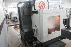 Haas VM-3 5-Axis CNC Vertical Machining Center, Haas TR-210 Trunnion, 40 Station Tool Changer, Probing, 300 PSI TSC, Chip Auger