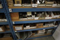 Teardrop Style Racking (2) 4' Sections, (18) Shelves,  with Contents of Mostly Aluminum Fixture Plates with Steel Hardware