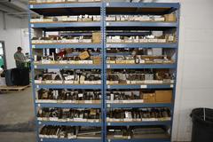 Teardrop Style Racking (2) 4' Sections, (16) Shelves,  with Contents of Mostly Aluminum Fixture Plates with Steel Hardware