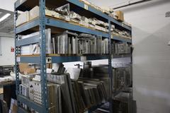 Teardrop Style Racking (2) 4' Sections, (10) Shelves,  with Contents of Mostly Aluminum Fixture Plates with Steel Hardware