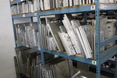 Teardrop Style Racking (2) 4' Sections, (10) Shelves,  with Contents of Mostly Aluminum Fixture Plates with Steel Hardware