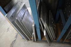 Teardrop Style Racking (1) Section with Contents of Mostly Aluminum Fixture Plates with Steel Hardware