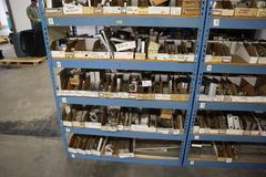 Teardrop Style Racking (2) 4' Sections, (16) Shelves,  with Contents of Mostly Aluminum Fixture Plates with Steel Hardware