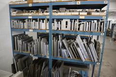 Teardrop Style Racking (2) 4' Sections, (10) Shelves,  with Contents of Mostly Aluminum Fixture Plates with Steel Hardware
