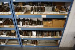 Teardrop Style Racking (2) 4' Sections, (16) Shelves,  with Contents of Mostly Aluminum Fixture Plates with Steel Hardware