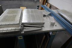Teardrop Style Racking (1) Section with Contents of Mostly Aluminum Fixture Plates with Steel Hardware