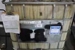 Schutz 300 Gallon Plastic Oil Container with Metal Caging with Small Amount of Fuel Oil